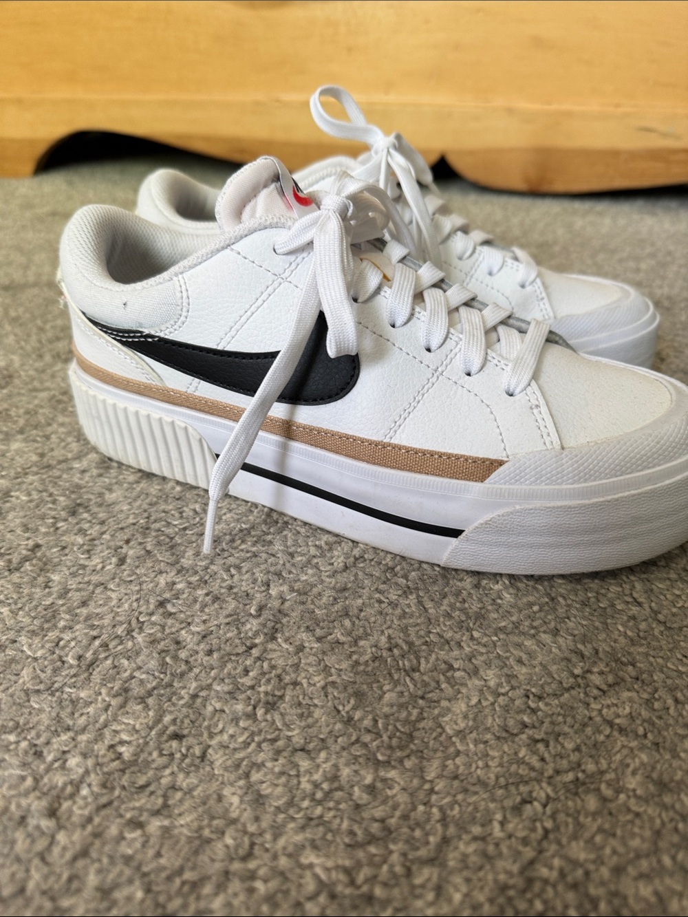 Nike Women's White Sneakers with Black Swoosh and Tan Stripe